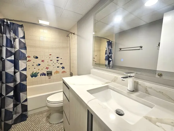 a bathroom with a sink toilet and shower