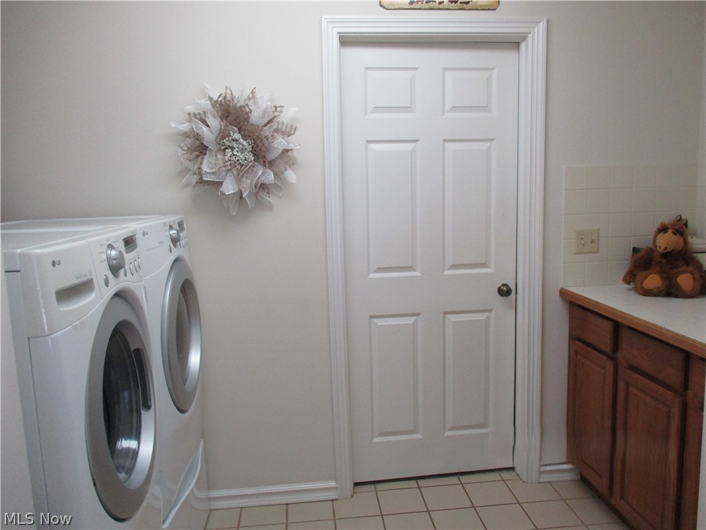 7540 Kennard Road Seville, OH 44273 - Photo 26 of 37 Clothes washing area featuring light tile flooring and washing machine and clothes dryer