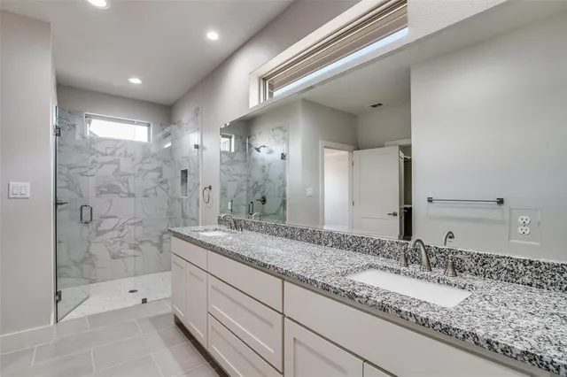 a bathroom with a granite countertop sink mirror and double