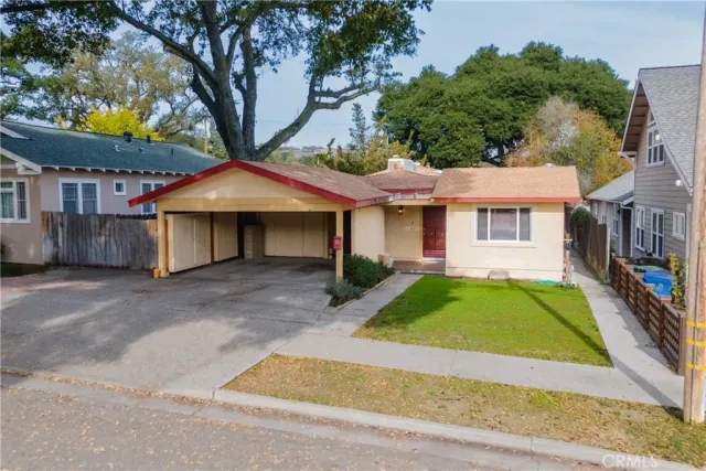 a front view of a house with garden