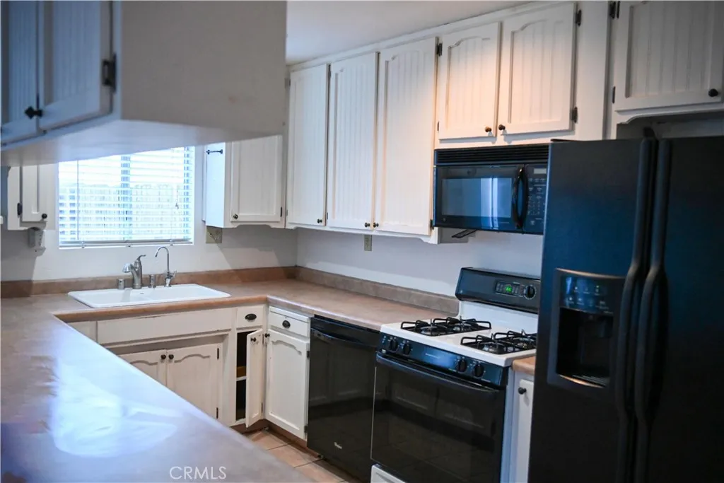 309 15th Street Paso Robles, CA 93446 - Photo 9 of 23 a kitchen with stainless steel appliances granite countertop a sink stove and refrigerator
