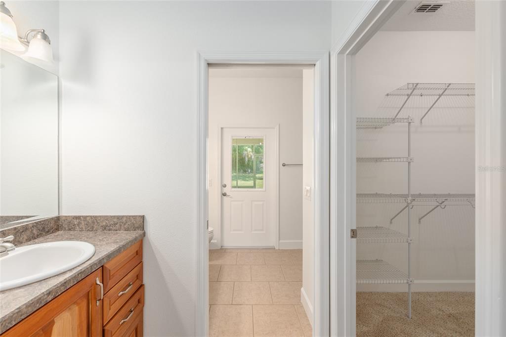 4735 Southeast 112th Street Road Belleview, FL 34420 - Photo 33 of 73 a bathroom with a granite countertop sink and a mirror