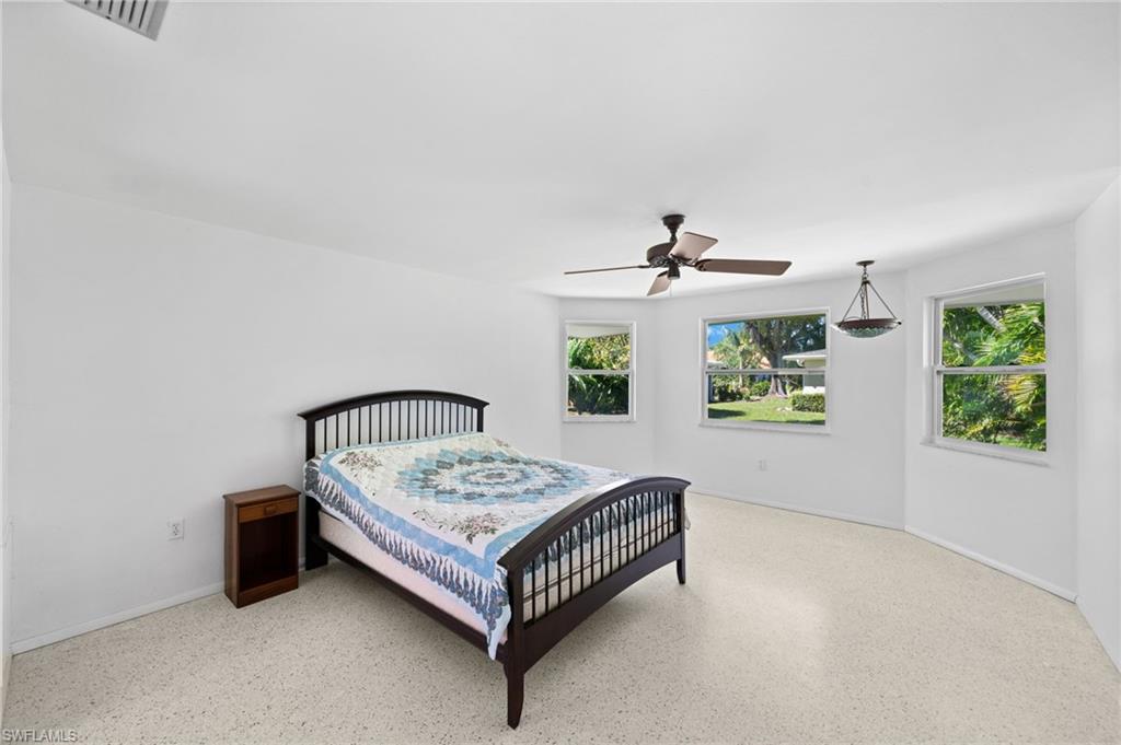 6 Maui Circle Naples, FL 34112 - Photo 12 of 22 a bedroom with a bed and window