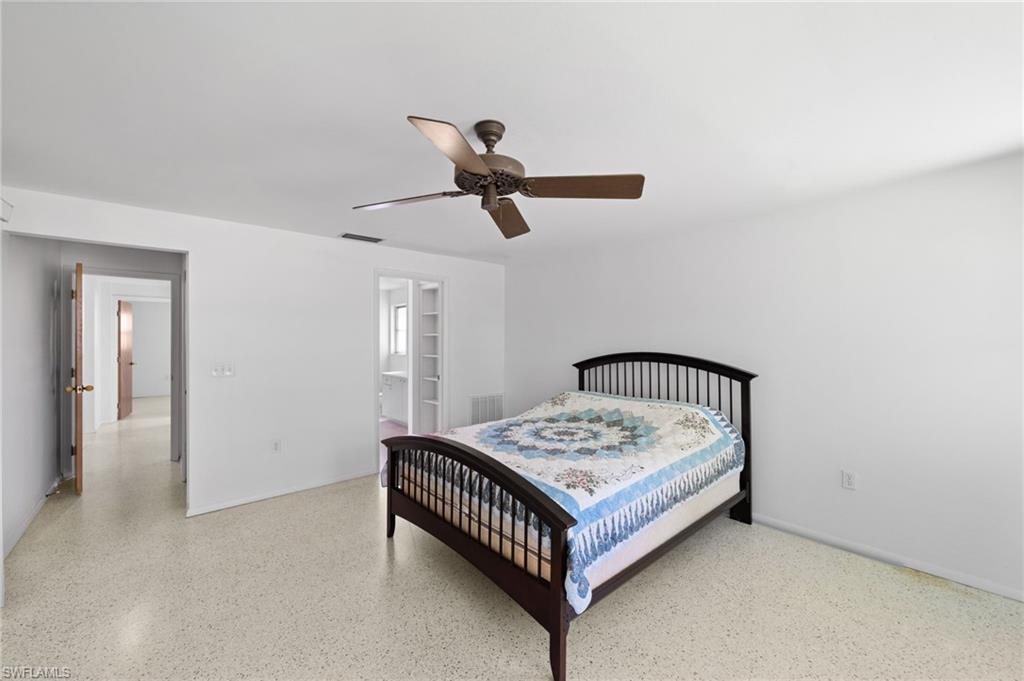 6 Maui Circle Naples, FL 34112 - Photo 13 of 22 a bed sitting in a bedroom next to a window