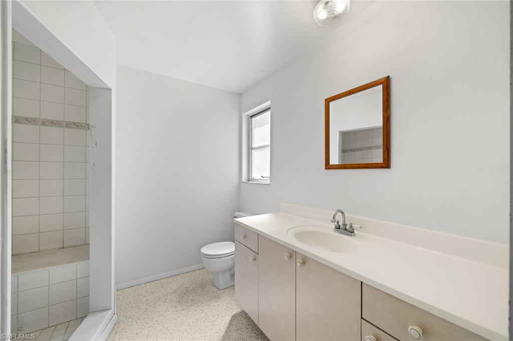 6 Maui Circle Naples, FL 34112 - Photo 14 of 22 a bathroom with a toilet sink and mirror