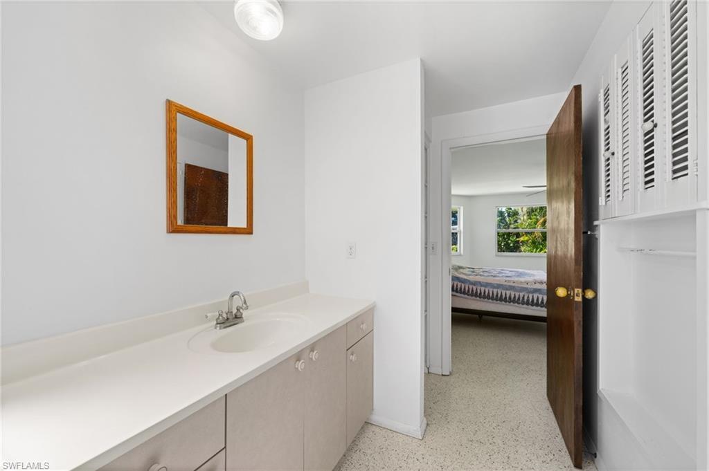 6 Maui Circle Naples, FL 34112 - Photo 15 of 22 a en suite bathroom with a sink and a mirror