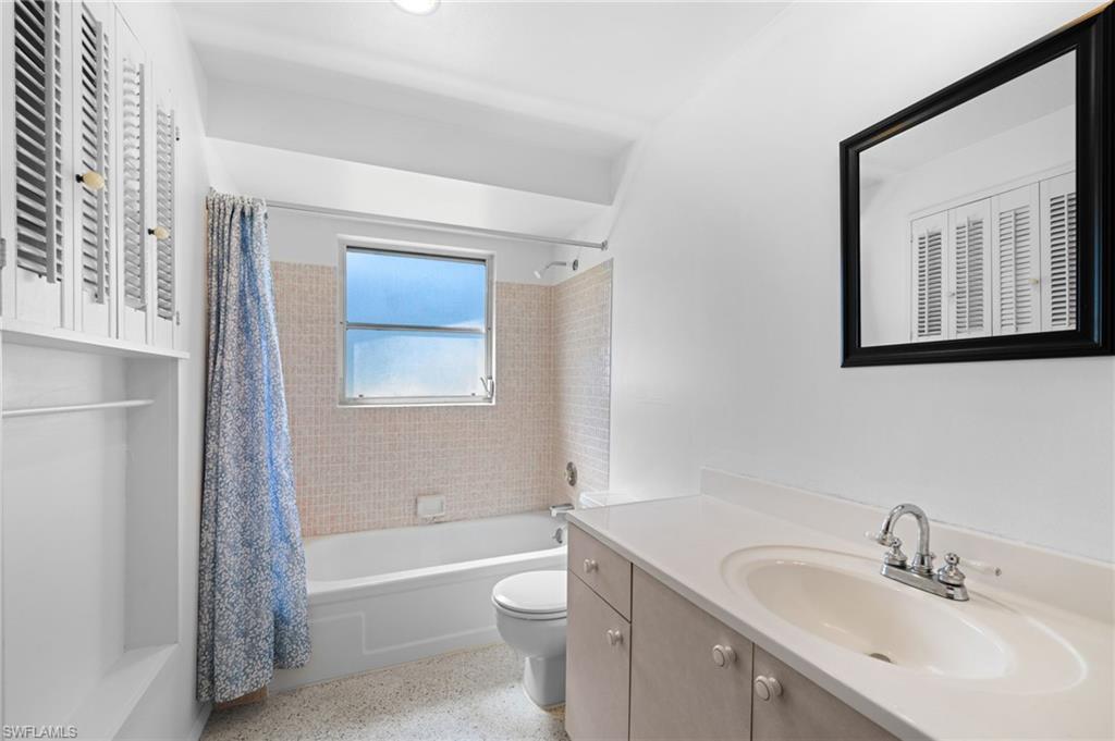 6 Maui Circle Naples, FL 34112 - Photo 18 of 22 a bathroom with a sink toilet and shower