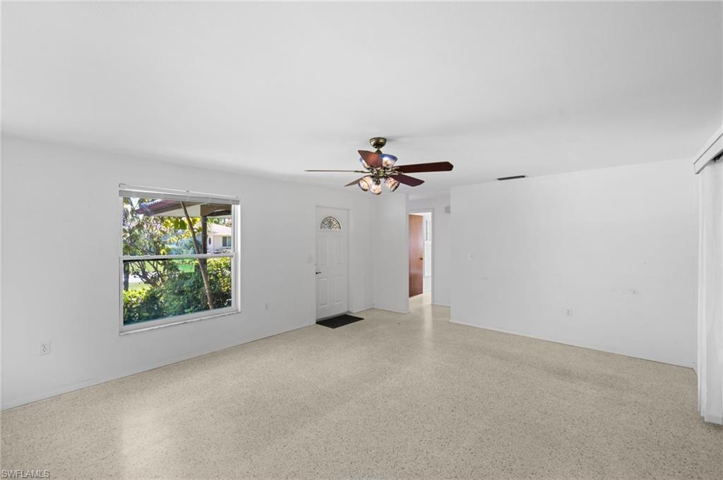 6 Maui Circle Naples, FL 34112 - Photo 3 of 22 an empty room with windows and fan