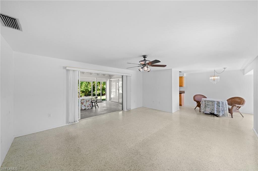 6 Maui Circle Naples, FL 34112 - Photo 4 of 22 an empty room with windows and flowerpot