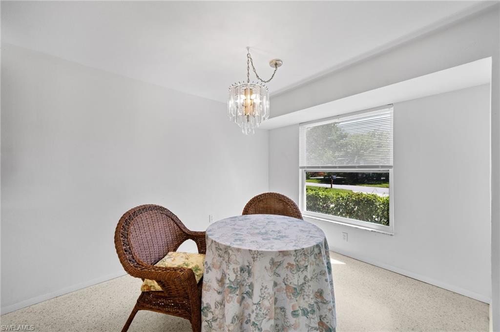 6 Maui Circle Naples, FL 34112 - Photo 6 of 22 a table and chairs in a room