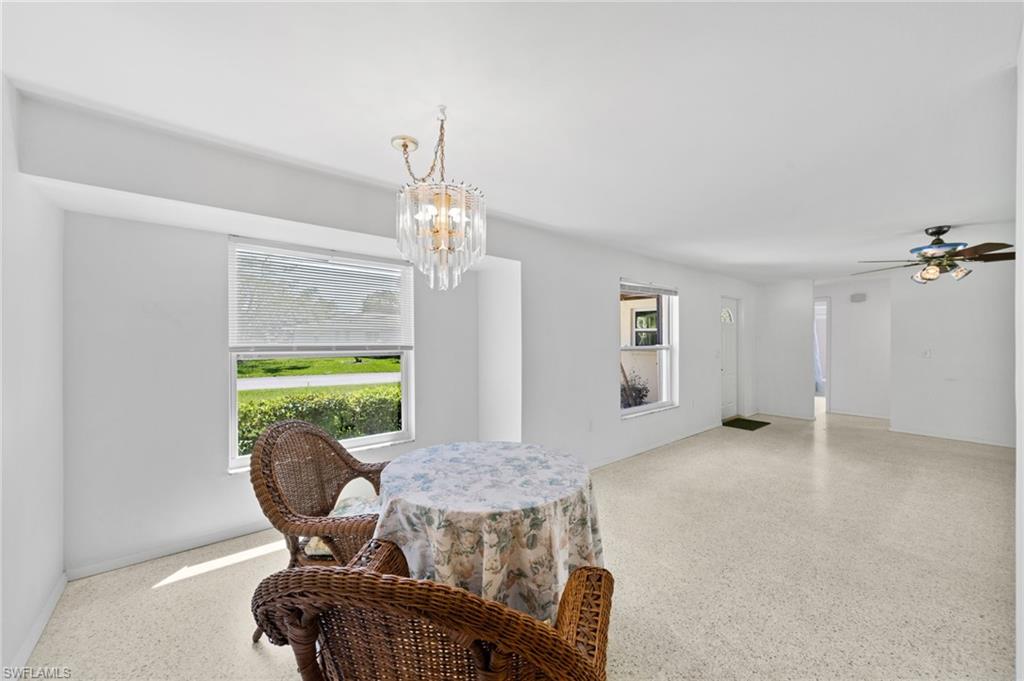 6 Maui Circle Naples, FL 34112 - Photo 7 of 22 a living room with furniture and a chandelier