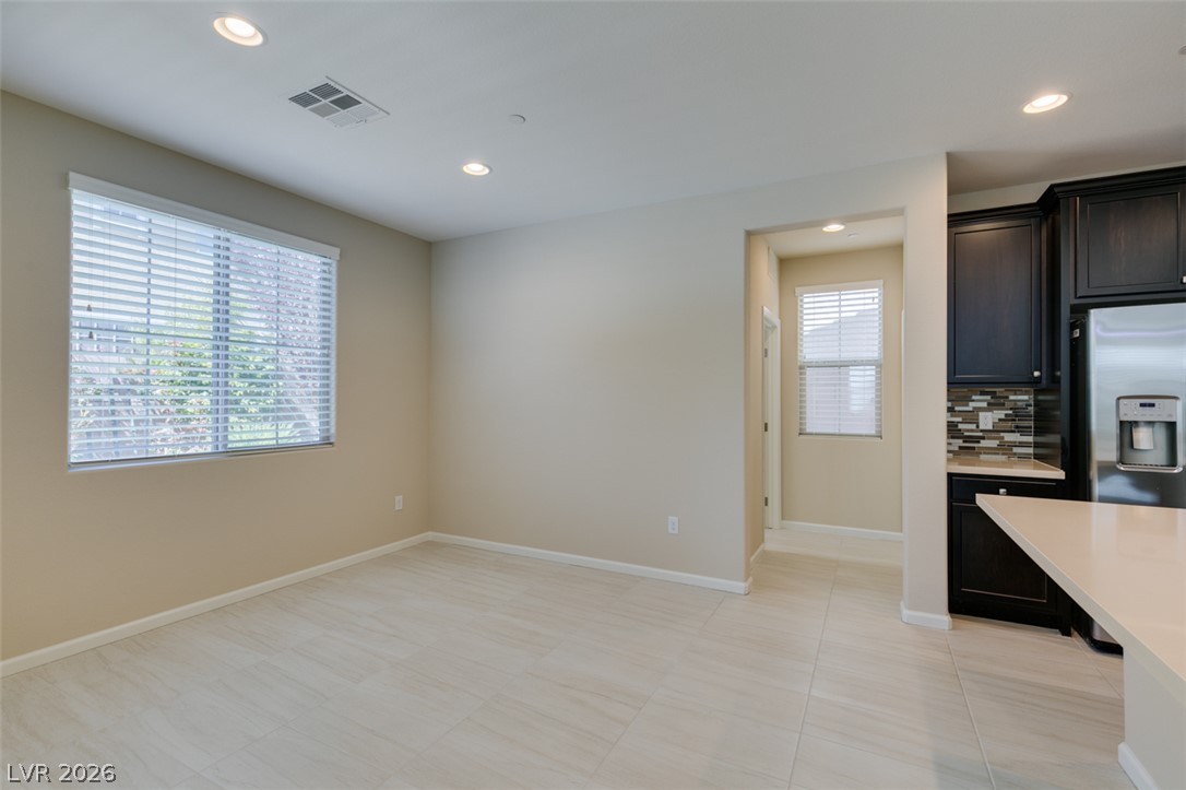 2549 Sable Ridge Street Henderson, NV 89044 - Photo 17 of 48 Recessed lighting illuminates the open-concept space, with sleek tile flooring flowing throughout.