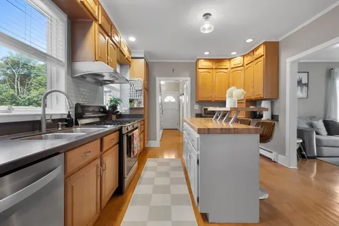 a kitchen with counter top space a sink cabinets and appliances