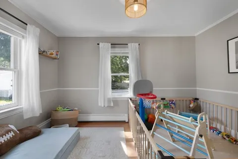 a living room with furniture chess table and a window