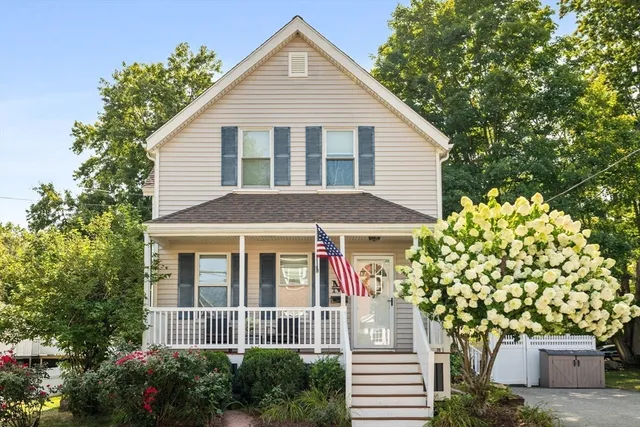 a front view of a house with a garden