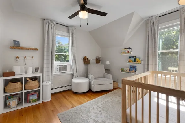 a bedroom with furniture and a large window