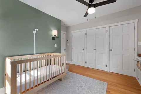 a view of a bedroom with wooden floor