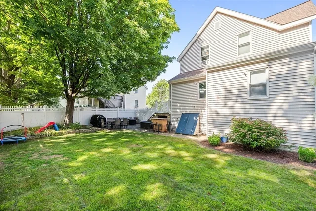 a view of a house with backyard and sitting area