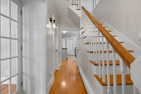 a view of staircase with railing and white walls