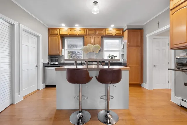 a kitchen with a sink and chairs
