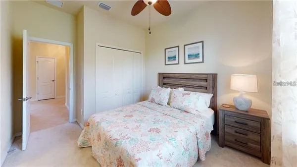 a bedroom with a bed and a chandelier