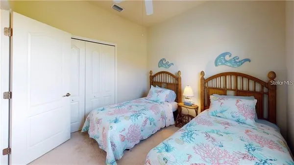 a bedroom with a bed window and a chandelier
