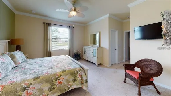 a bedroom with a bed and a chandelier