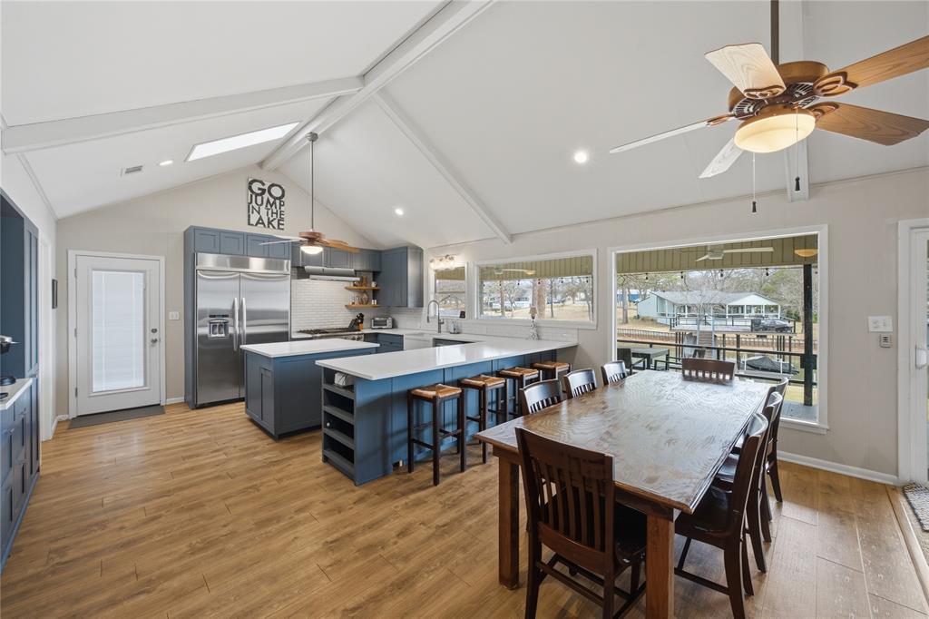 111 Ridgeoak Way Tool, TX 75143 - Photo 6 of 24 a dining room with stainless steel appliances kitchen island a table chairs and a refrigerator