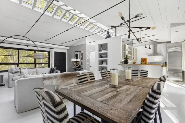 a dining room with furniture and a window
