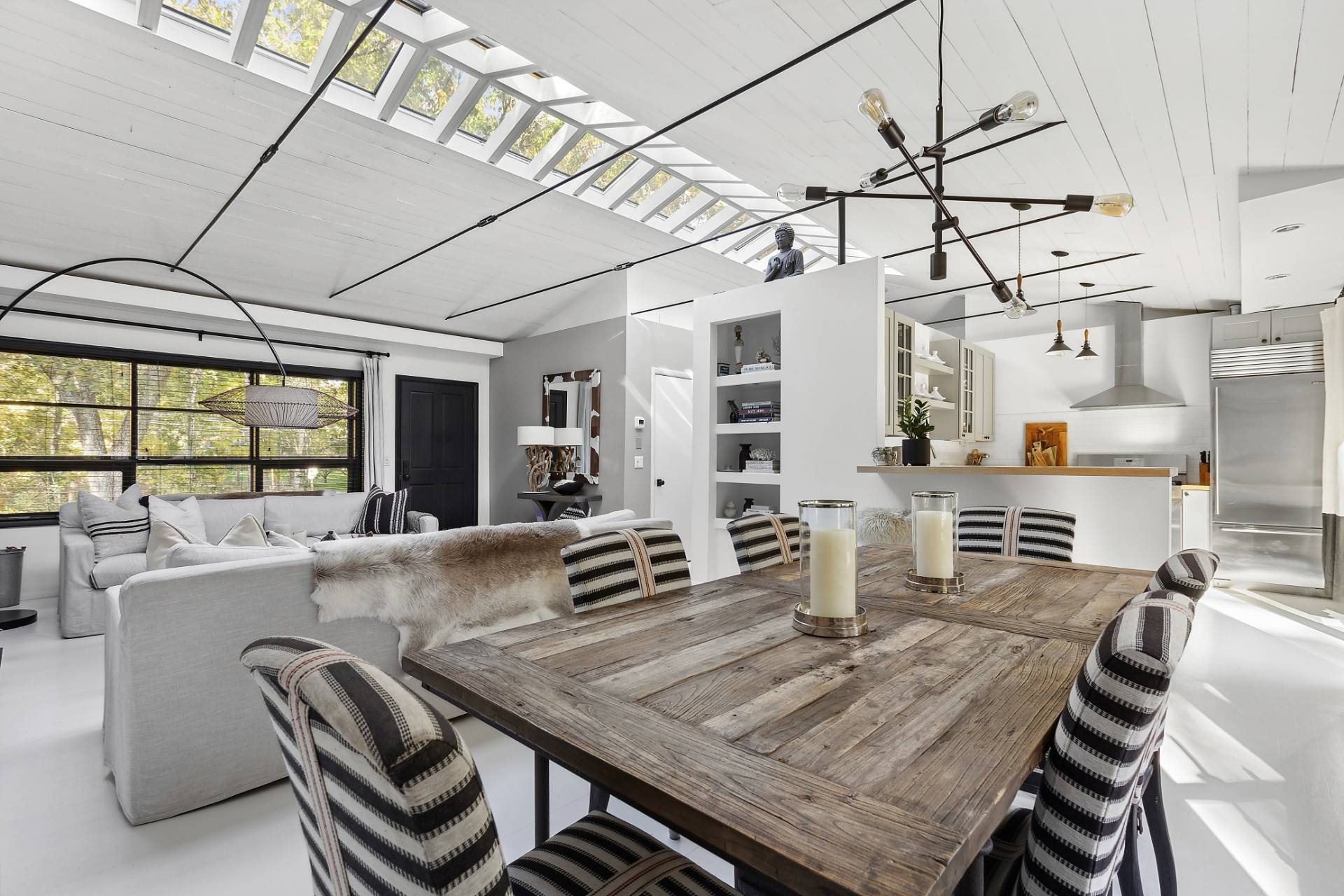 1510 Sagg Road Sag Harbor, NY 11963 - Photo 5 of 22 a kitchen with a table and chairs in it