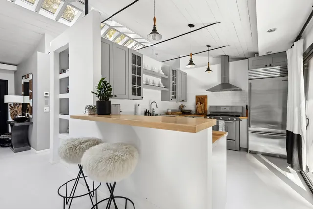 a kitchen with stainless steel appliances granite countertop a sink and stove top oven