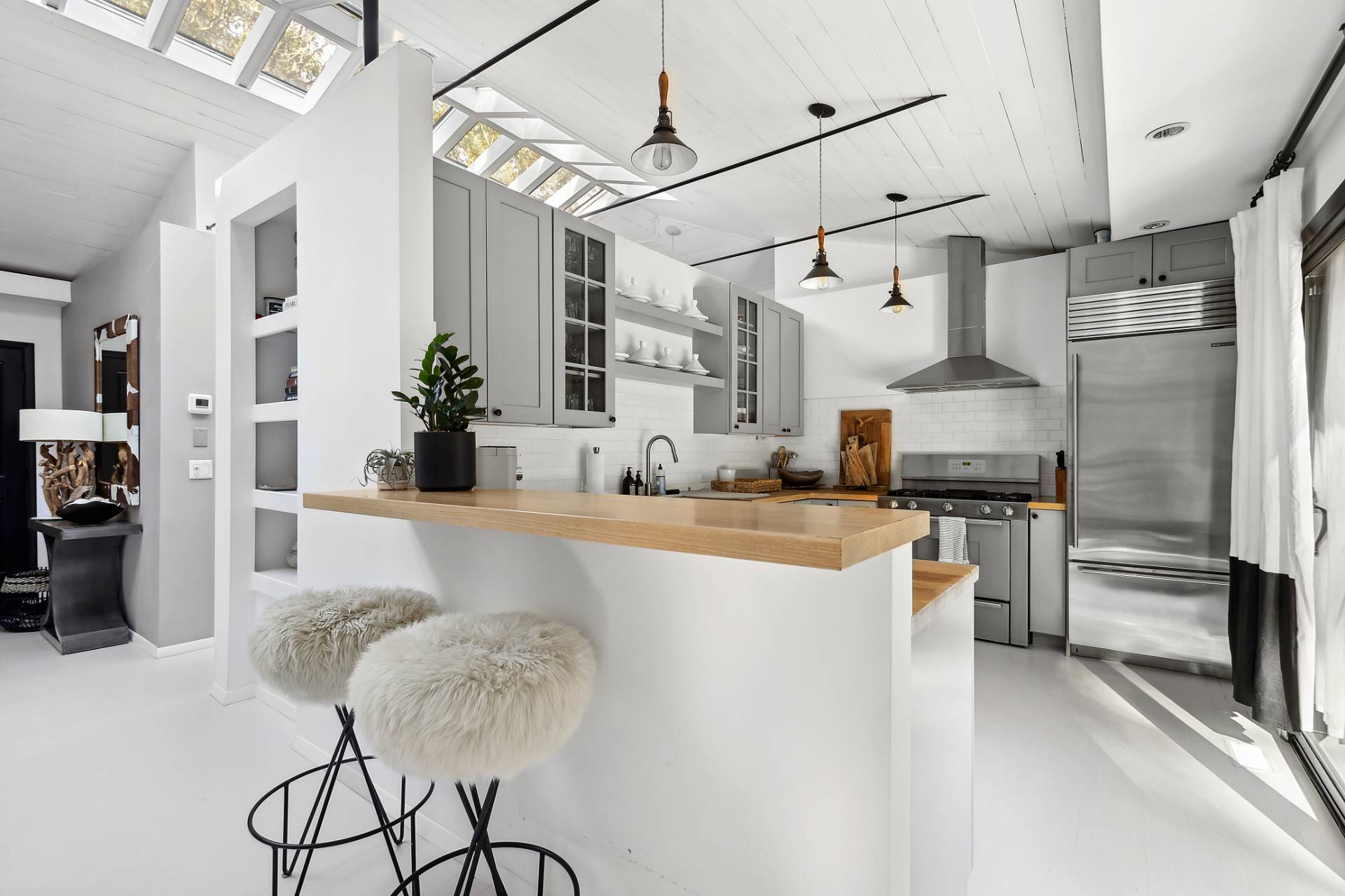 1510 Sagg Road Sag Harbor, NY 11963 - Photo 8 of 22 a kitchen with stainless steel appliances granite countertop a refrigerator and a sink