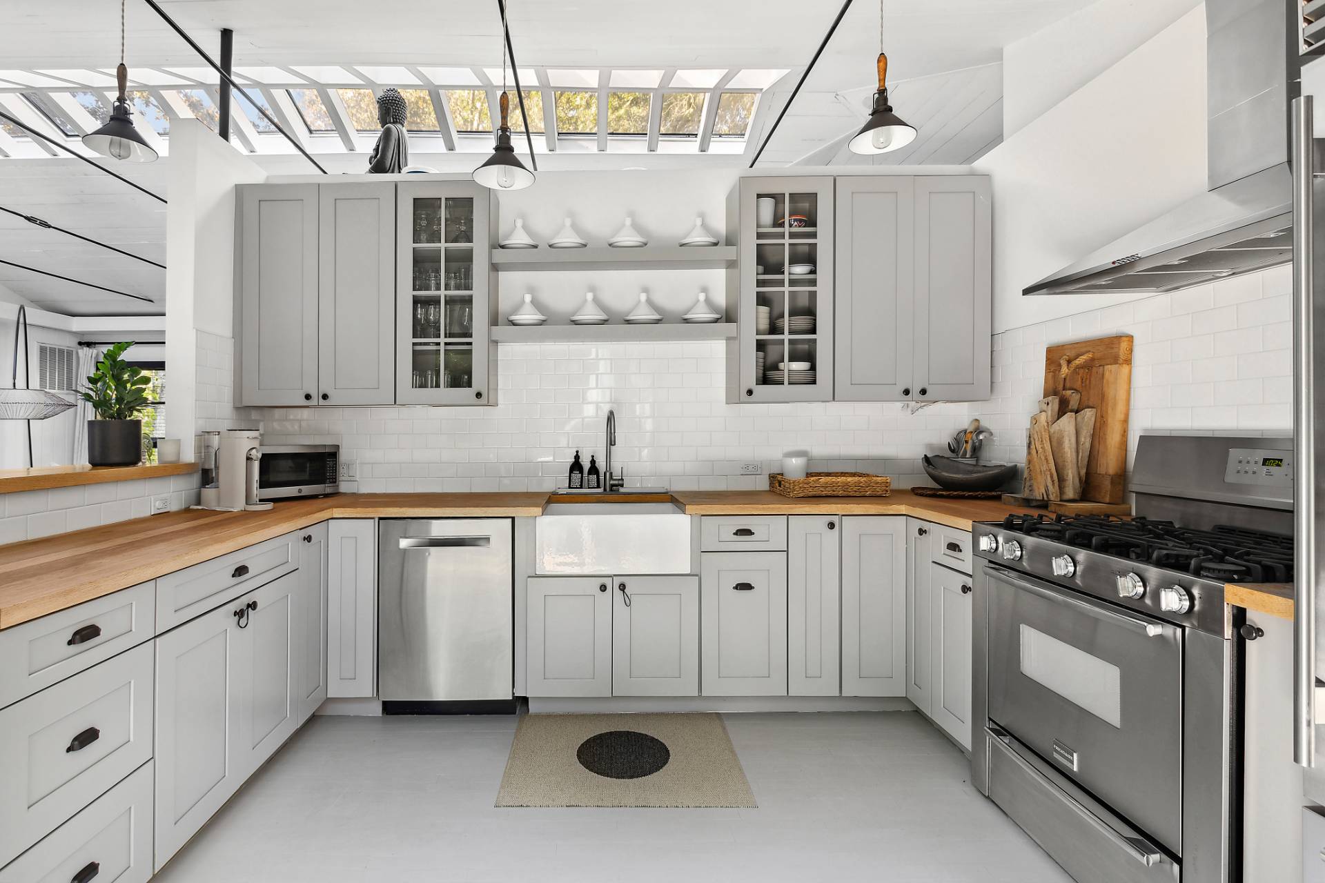 1510 Sagg Road Sag Harbor, NY 11963 - Photo 9 of 22 a kitchen with stainless steel appliances granite countertop a sink and stove top oven