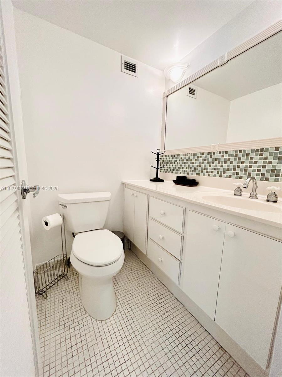 100 Lincoln Road, Unit 1621 Miami Beach, FL 33139 - Photo 11 of 15 a bathroom with a sink a toilet and a mirror