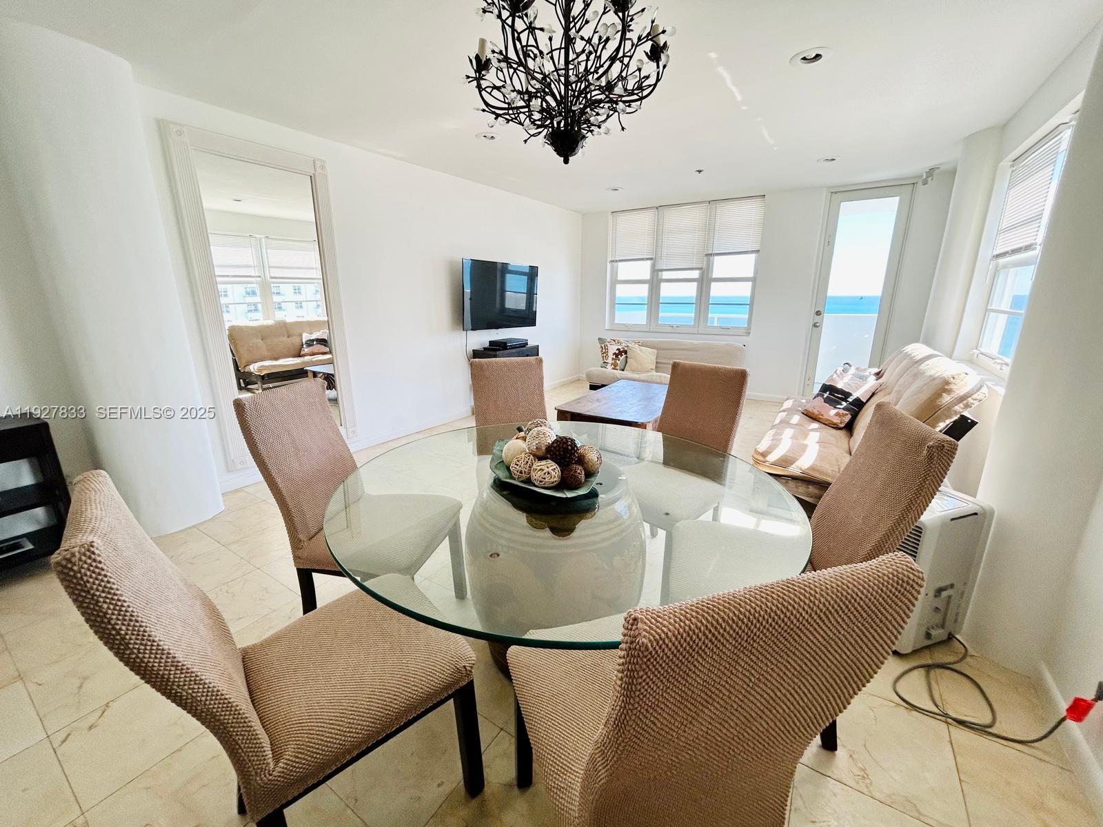100 Lincoln Road, Unit 1621 Miami Beach, FL 33139 - Photo 5 of 15 a living room with furniture and a large window