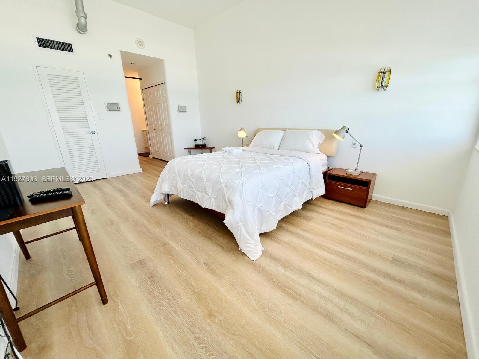 100 Lincoln Road, Unit 1621 Miami Beach, FL 33139 - Photo 6 of 15 a bedroom with a bed and wooden floor
