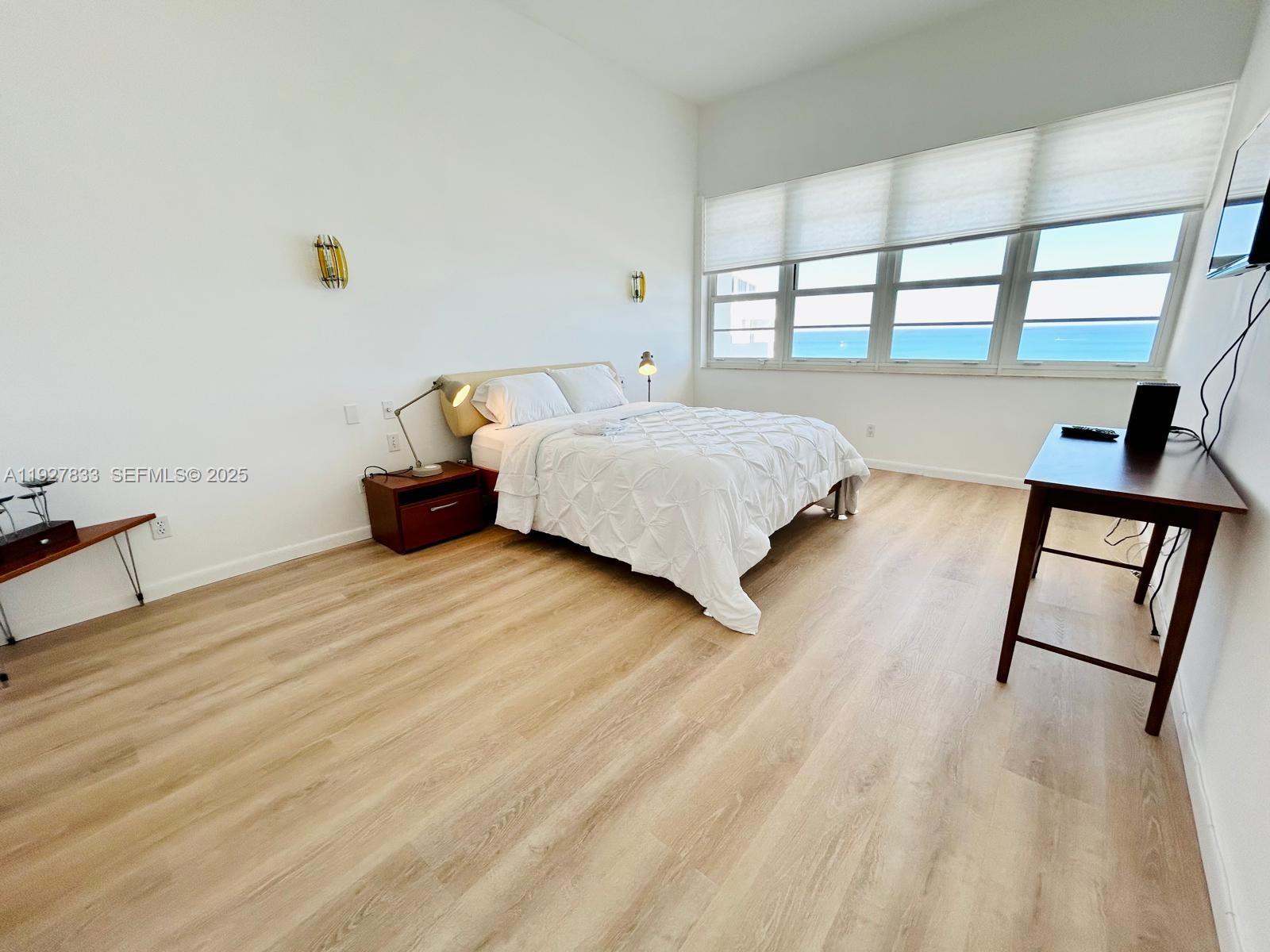 100 Lincoln Road, Unit 1621 Miami Beach, FL 33139 - Photo 8 of 15 a bedroom with a bed and wooden floor