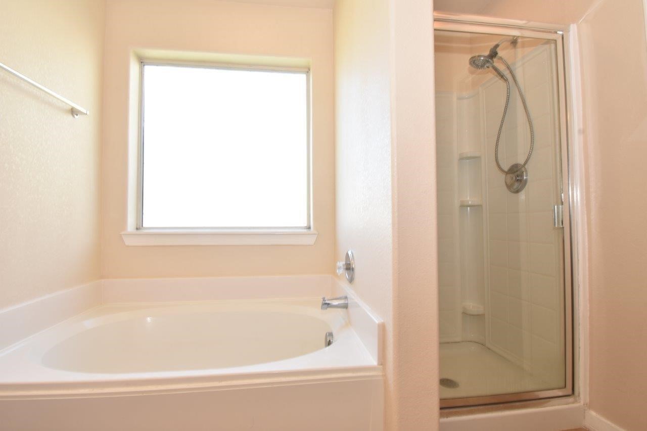 1126 Desert Oasis Lane Rosenberg, TX 77471 - Photo 10 of 16 a bathroom with a bathtub and a shower