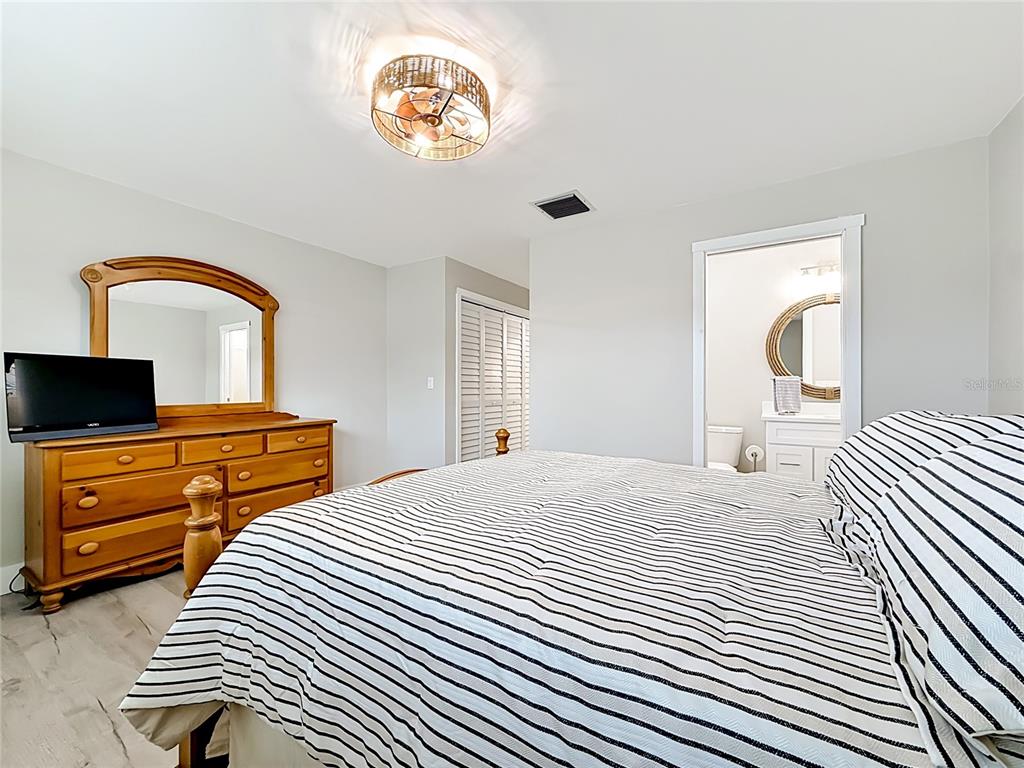 508 Shore Drive Largo, FL 33771 - Photo 13 of 31 a bedroom with a bed and a television