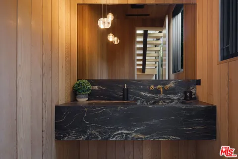 a bathroom with a sink and mirror
