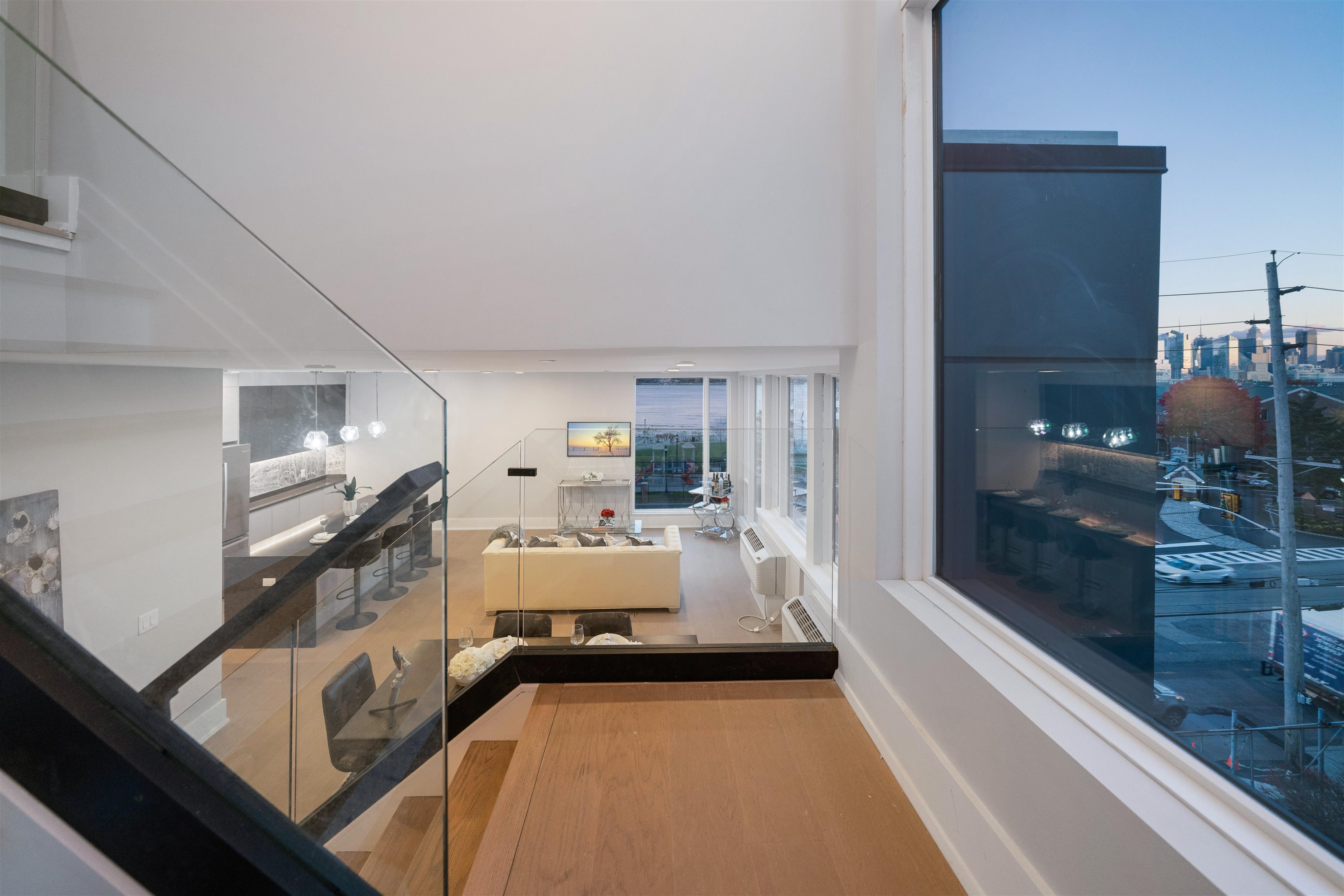 7101 River Road, Unit 310B North Bergen, NJ 07047 - Photo 2 of 36 a large white room with a large window and a couch