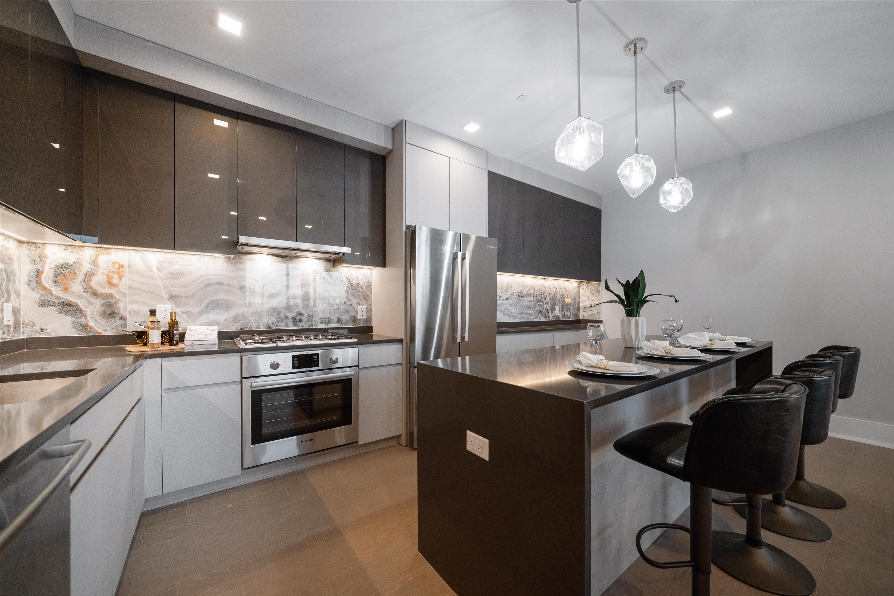 7101 River Road, Unit 310B North Bergen, NJ 07047 - Photo 4 of 36 a kitchen with stainless steel appliances granite countertop a sink a stove a refrigerator and island