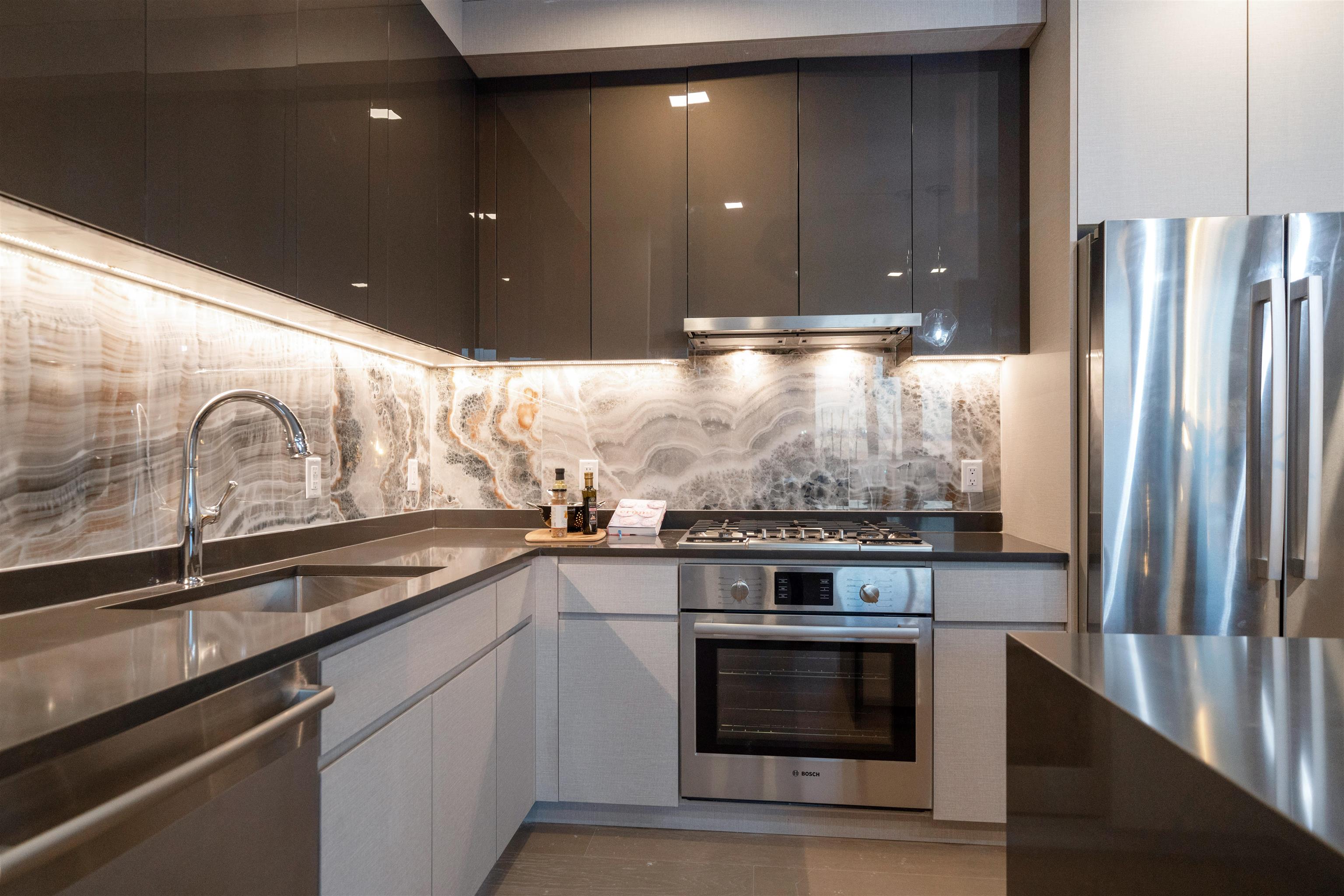 7101 River Road, Unit 310B North Bergen, NJ 07047 - Photo 5 of 36 a kitchen with stainless steel appliances granite countertop a stove and a refrigerator