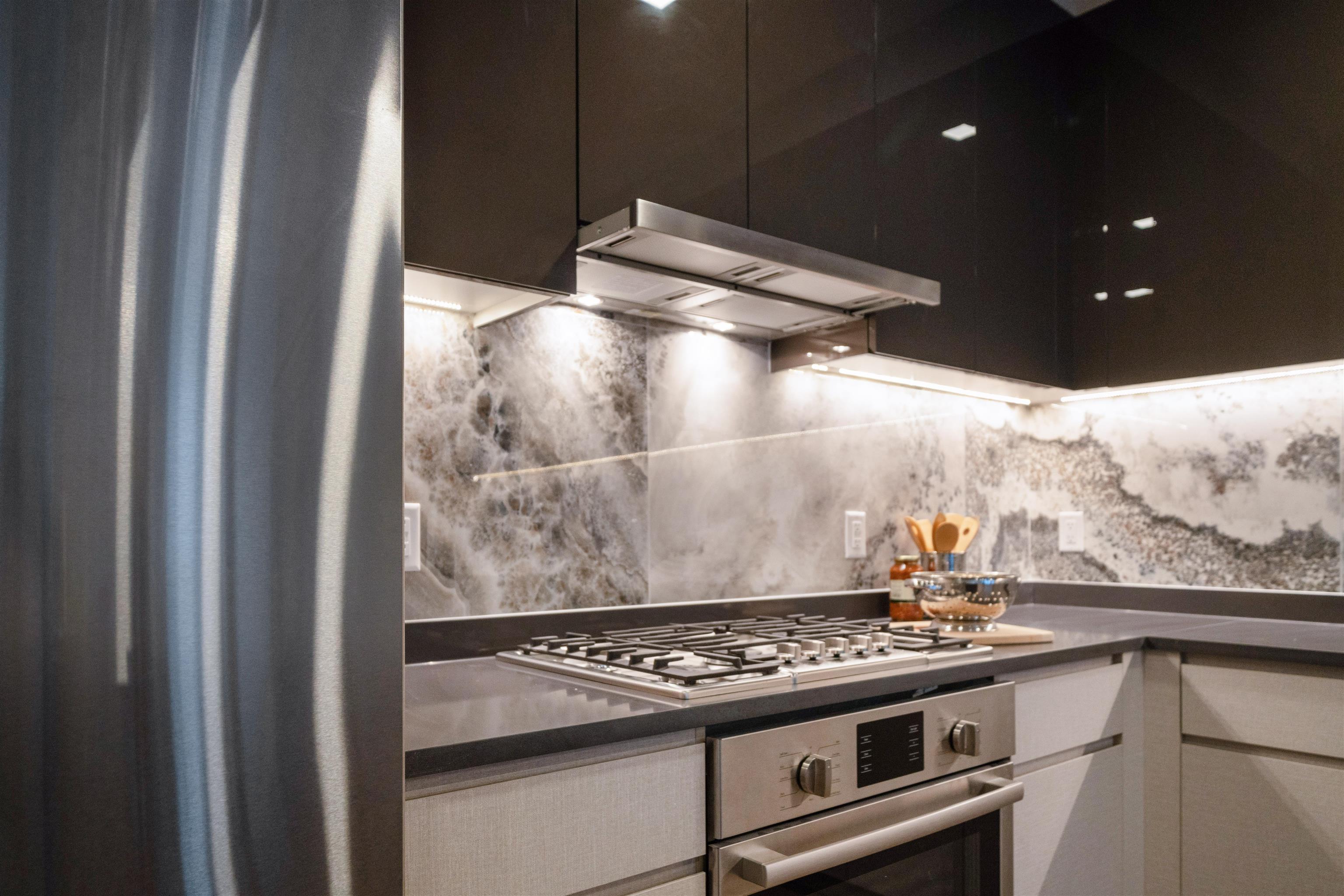 7101 River Road, Unit 310B North Bergen, NJ 07047 - Photo 6 of 36 a stove top oven sitting inside of a kitchen