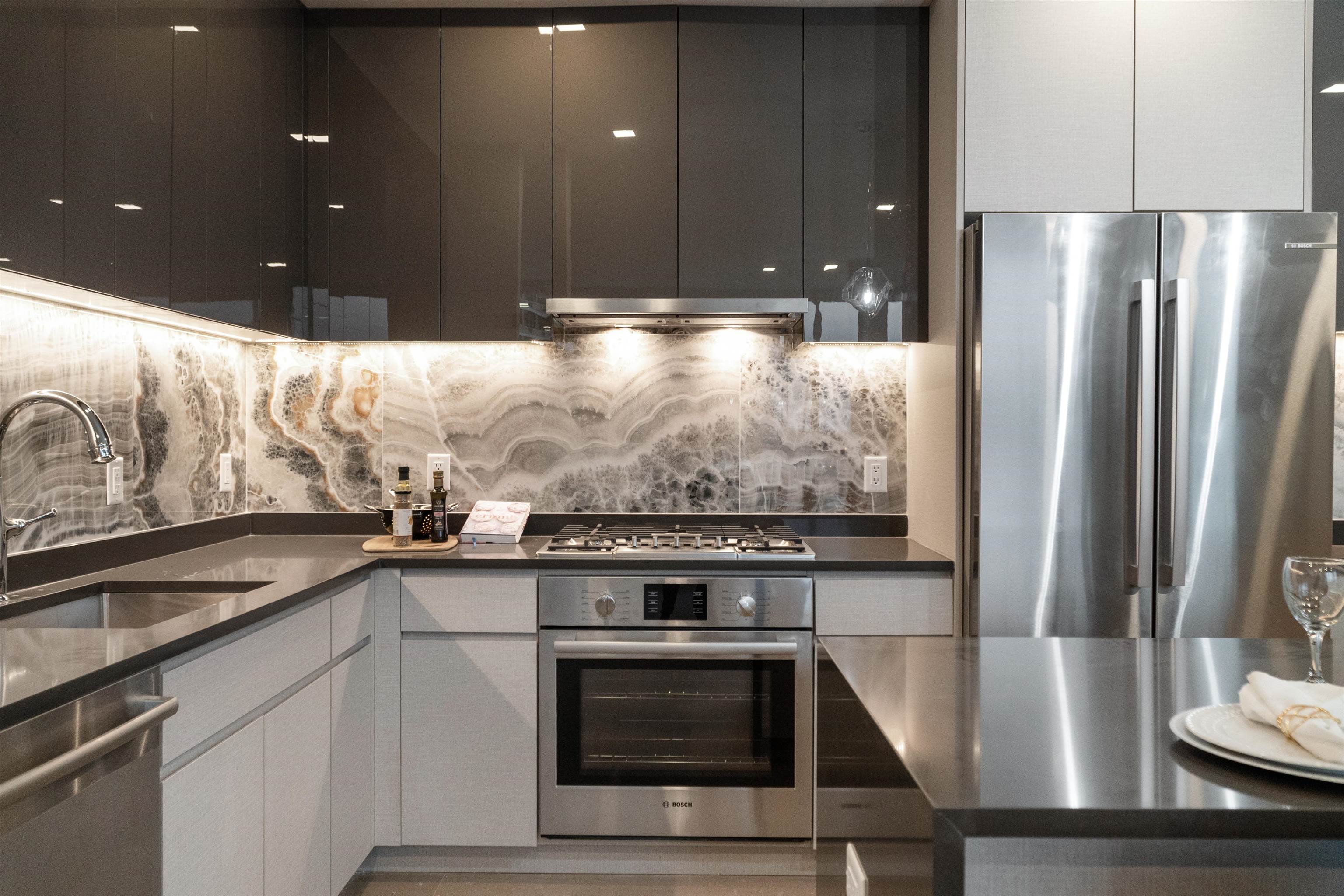 7101 River Road, Unit 310B North Bergen, NJ 07047 - Photo 7 of 36 a kitchen with stainless steel appliances granite countertop a stove and a refrigerator