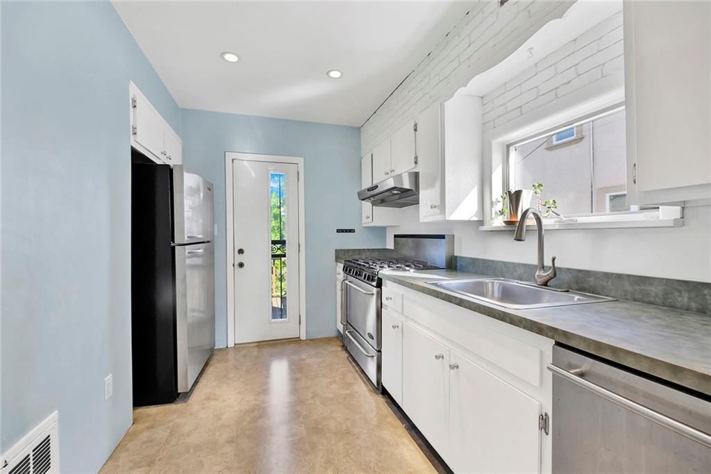 2991 Quentin Road Brooklyn, NY 11229 - Photo 13 of 30 a kitchen with a sink stove and refrigerator