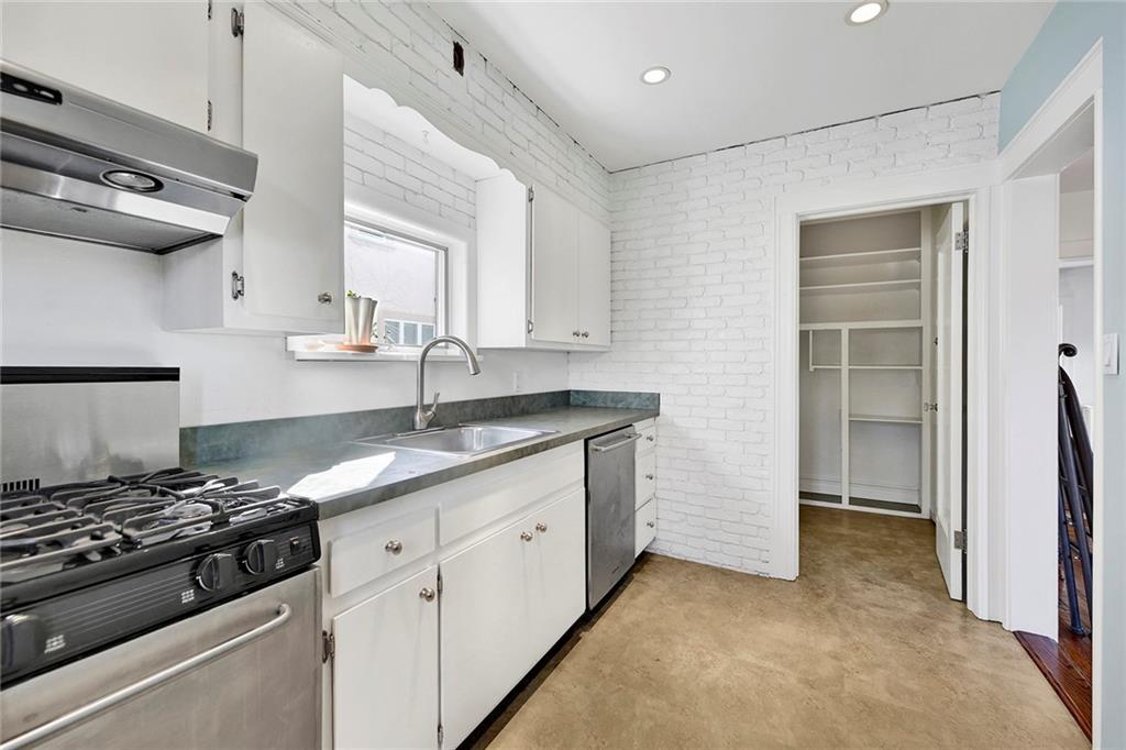 2991 Quentin Road Brooklyn, NY 11229 - Photo 14 of 30 a kitchen with granite countertop a sink stove and cabinets