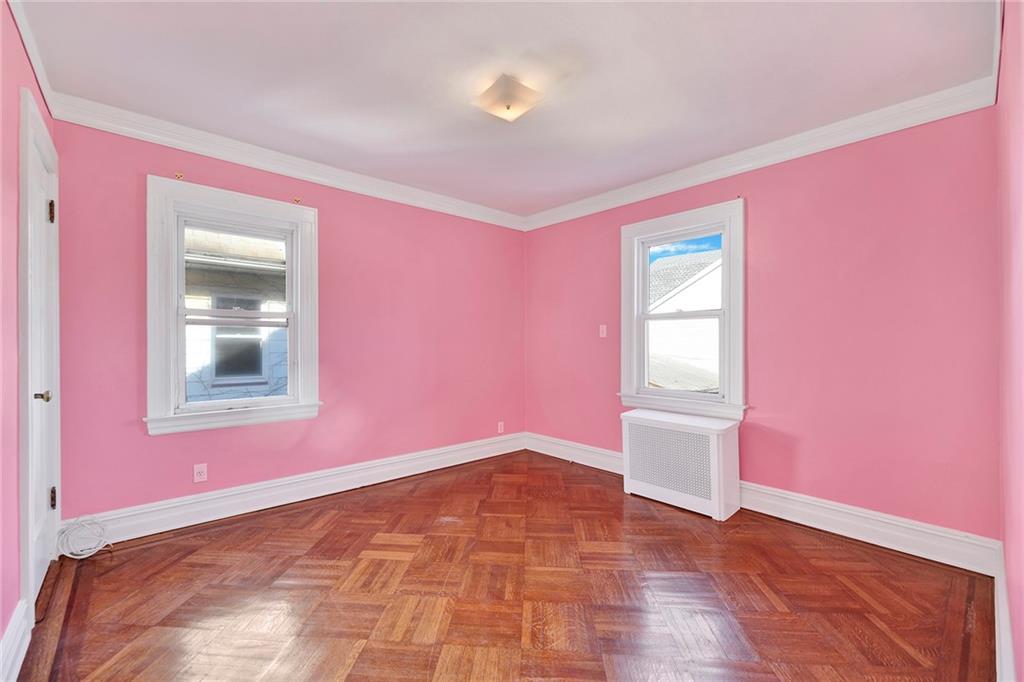 2991 Quentin Road Brooklyn, NY 11229 - Photo 18 of 30 a view of an empty room with window and wooden floor