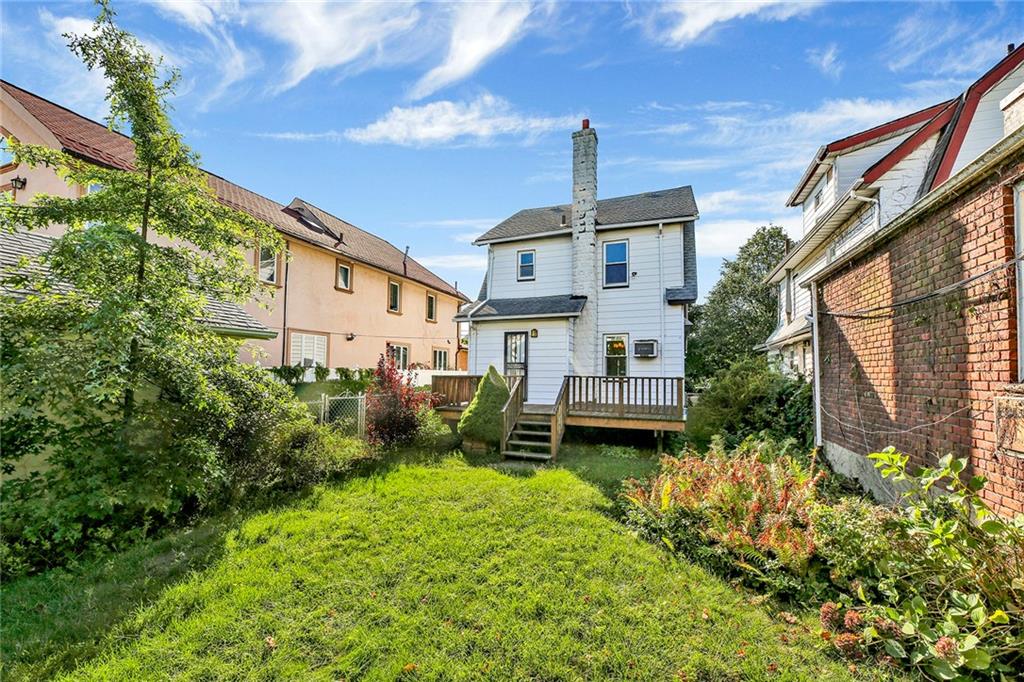 2991 Quentin Road Brooklyn, NY 11229 - Photo 29 of 30 a front view of a house with garden and plants