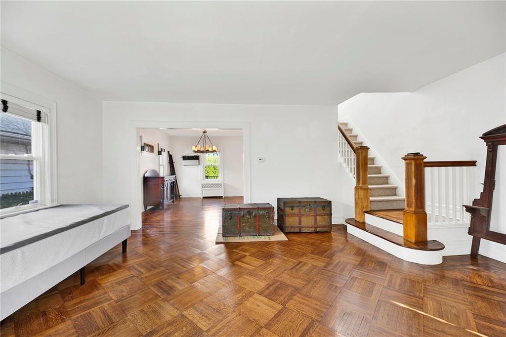 2991 Quentin Road Brooklyn, NY 11229 - Photo 5 of 30 a hallway with a couch and chandelier